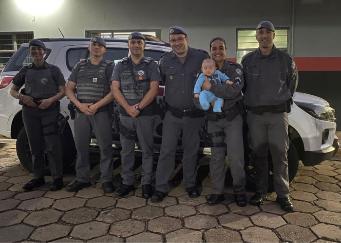 Policiais militares carregando beb&ecirc; ap&oacute;s o atendimento