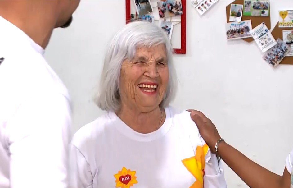 Imagem da idosa sorrindo.