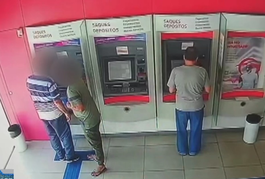 Pessoas em caixas eletr&ocirc;nicos de uma ag&ecirc;ncia banc&aacute;ria.